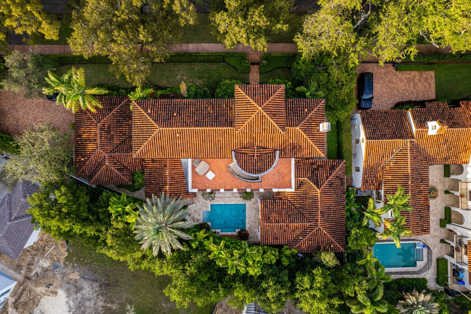 Aerial view of a Miami neighborhood with tile and shingle rooftops