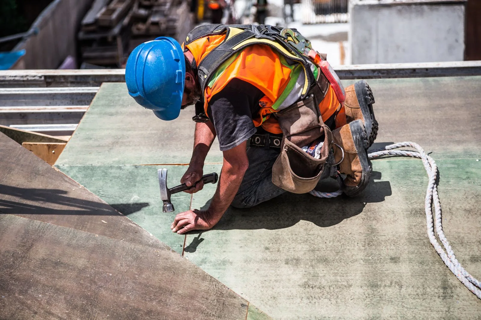 Roofer in a hard hat installing a new roof